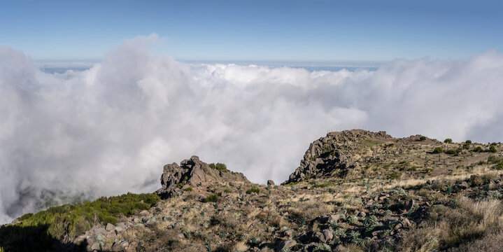 slope above the clouds at Miradouro de Areeiro peak, Madeira