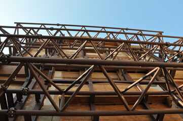 Low-angle shot of iron constructions to support houses after an earthquake