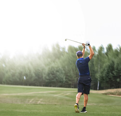 A golfer is practicing during a stroke. Golfers seem to do sports and hobbies on vacation. The...