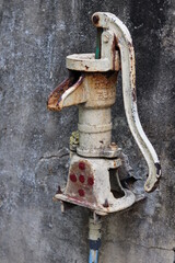 Rusted vintage water pump with rusty texture background