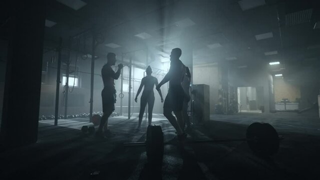 sport team of bodybuilders or powerlifters training in gym together, men and women are hitting fists