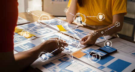 developer team brainstorming on their project with laptop, smartphone and digital tablet.