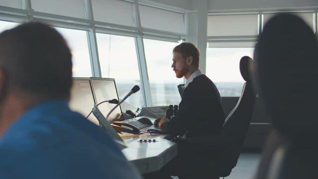 Male Air Traffic Control officer Talk in microphonel in Airport Tower. Realtime