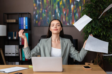 Mental balance calm attractive young buisness woman in fashionable suit meditating in home office...