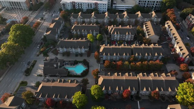 Housing apartment building homes in downtown urban USA area. Aerial truck shot in fall autumn foliage.