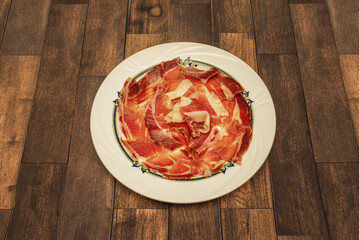 One of the most typical Spanish tapas, a plate of Iberian ham cut with a knife © Toyakisfoto.photos