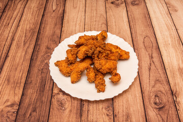 Curly is a common dish of Cantonese cuisine in southern China. The chicken is fried in such a way that the skin is extremely crispy