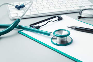 Medical background with stethoscope and computer keyboard, online healthcare concept
