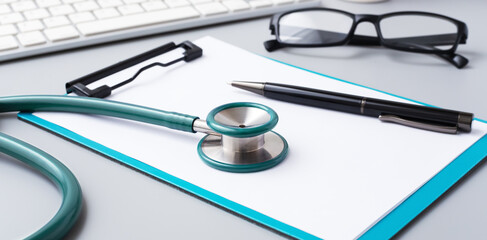 Stethoscope with clipboard and pen on doctor desk