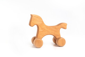 Toy - handmade wooden horse on wheels isolated on white background