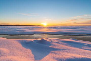 Sunset over the frosen sea. Pörkenäs, Finland