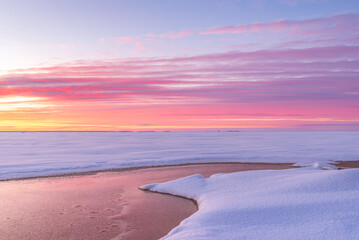 Pink sunset over the frozen sea. Pörkenäs, Finland