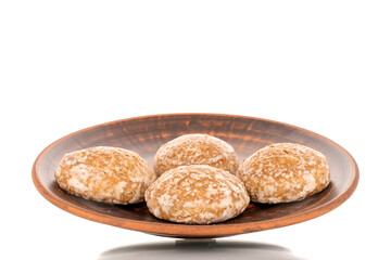 Two sweet tasty gingerbread cookies on a clay plate, macro, isolated on white background.