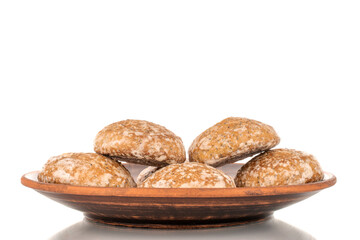 Two sweet tasty gingerbread cookies on a clay plate, macro, isolated on white background.