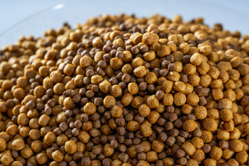 Closeup of a pile of fresh fish feed pellets