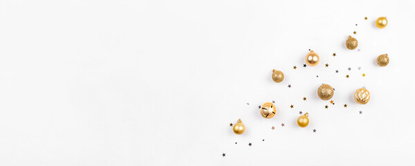 Festive white background with gold Christmas decorations. Flat lay, top view.