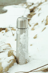 Casual steel thermos standing outdoor near river