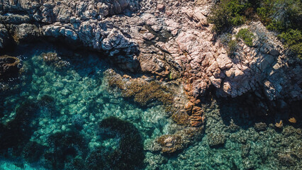 Colorful beach and sea in summer colours. Coast from aerial view. Exclusive landscape scene from nature. Waves, blue water, gold sand, turquoise shore, rocks, stones, premium exotic background