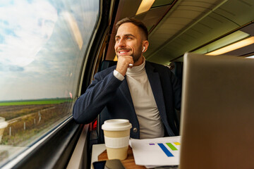 Young man thinking over he's project ideas as he looks out the window on his commute to work