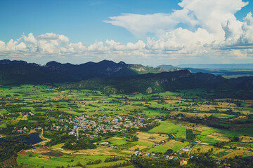 Picture from the highest point of Wat Khao Sam Yot.  Phu Pha Man District  Khon Kaen province with the sky, rice fields, mountains surrounding the countryside in Thailand.