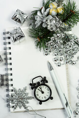 Christmas and New Year background with notepad, pen and decorations. To make a to-do list or a list of promises, select a place for your text. Layout.  Selective focus.