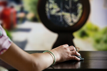 A child or teenager is playing computer video games on a large screen. Online video game technology and teen gaming addiction. Close-up child's hand with mouse