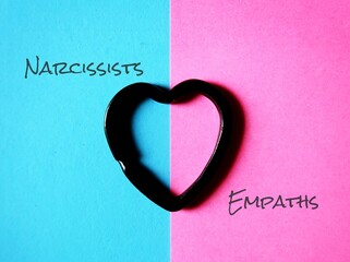 Heart on blue and pink background, with text NARCISSISTS and EMPATHS, concept of two types of...