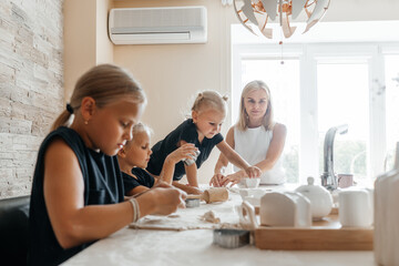 Obraz na płótnie Canvas Children making cookies in the kitchen at home.