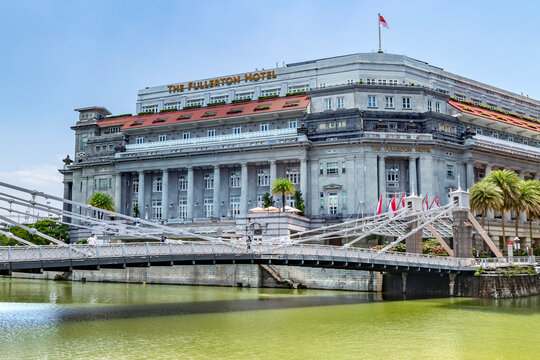 Southeast Asia, Singapore, November, 2022: Cavenagh Bridge next to Fullerton Hotel in Singapore. Fullerton Hotel was converted from an old post office.