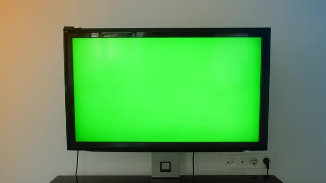TV Green Screen in living room. Chroma key screen for advertising.