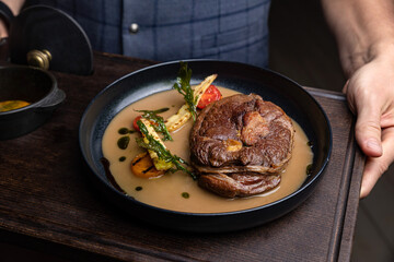 delicious fried steak in sauce in a restaurant
