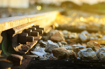 Close up of train railway steel track with head light of coming train