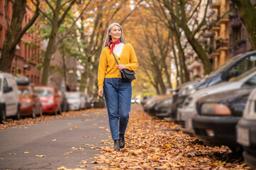 Long-haired woman walking in an autumn park