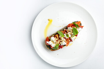 delicious bruschetta with cheese, meat, vegetables in a restaurant
