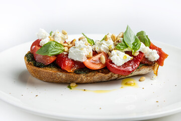 delicious bruschetta with cheese, meat, vegetables in a restaurant
