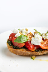 delicious bruschetta with cheese, meat, vegetables in a restaurant
