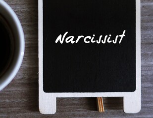 Chalkboard with handwritten text NARCISSIST, refers to people who has extreme self-involvement,...