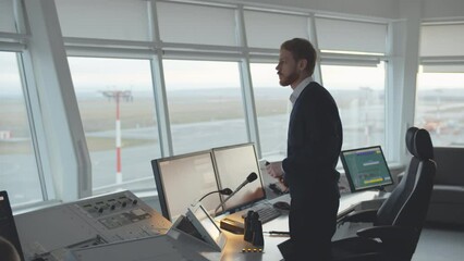  Air traffic controller make announcement on phone in the control tower. Realtime