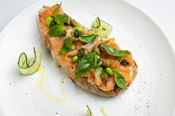 delicious bruschetta with cheese, meat, vegetables in a restaurant
