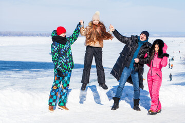 Young family of four walking outdoors in winter