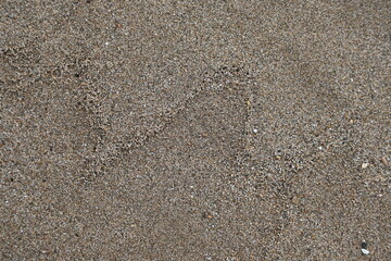 Fondo con detalle y textura de superficie de arena de playa, en tonos marrones