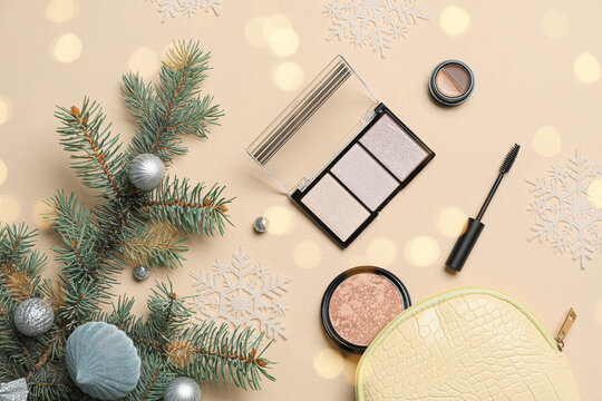 Bag with makeup cosmetics and Christmas decorations on light background