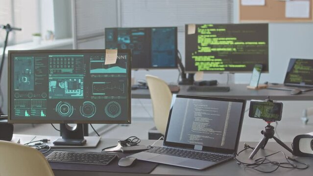 No people shot of processes of coding and working with computer network on screens of computer monitors at professional programmers office with modern tech equipment