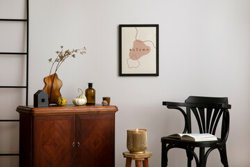 Warm and cozy living room interior with mock up poster frame with vintage sideboard, stylish black...