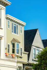 Row of modern house facades in the historic districts of downtown San Francisco California with wood and stucco exteriors