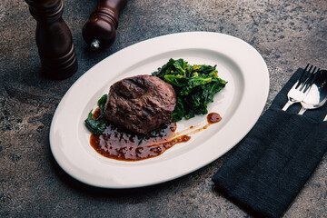 Beef steak with green salad and sauce