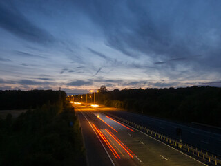Light trails on the M20 motorway at dusk, Kent, UK