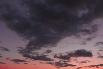 Naklejka na ściany i meble Pink purple clouds in the sky at dusk