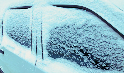 Close up frozen winter car covered snow, view side window on snowy background