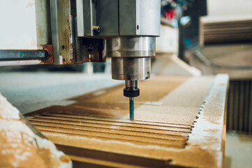 Close shot of a drilling cnc machine at wood machining industry